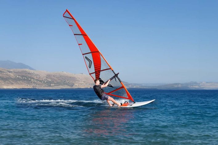 Windsurfer sailing on sea in Greece