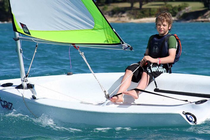 Boy sailing in sailing dinghy