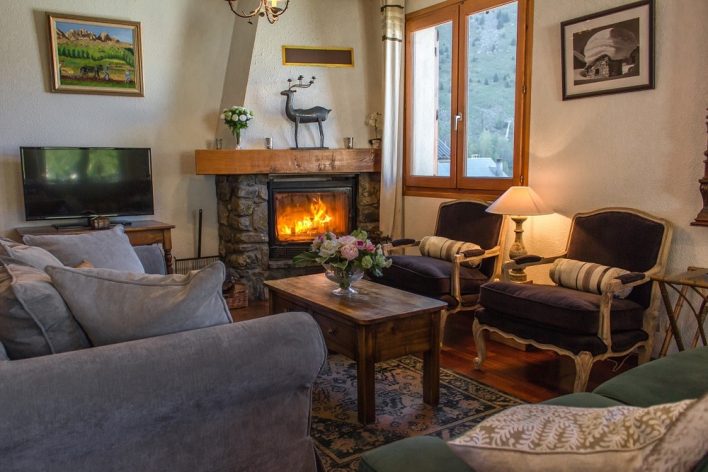A warm living room with a roaring fire