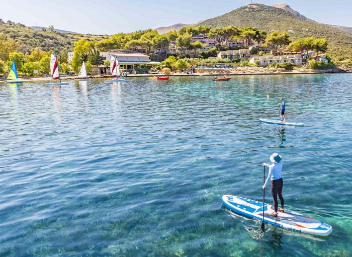 3 people paddle boarding in Greece on an active holiday