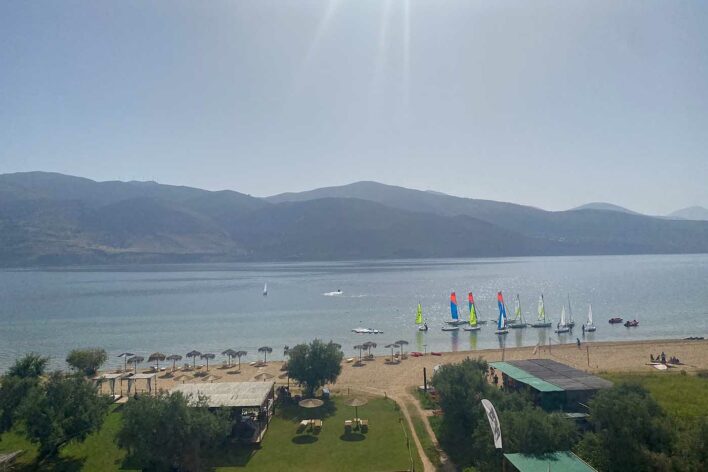 Boats moored in the shallows with mountains in the distance