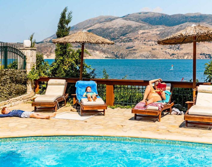 Family relaxing by the pool over looking the watersports area.