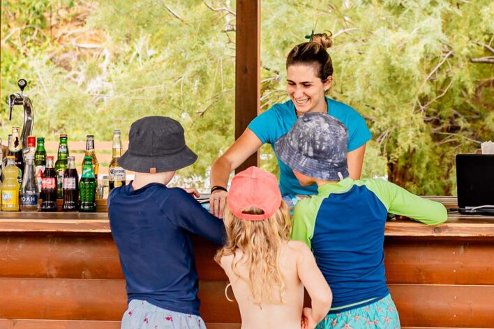 Children buy ice creams at a beach bar