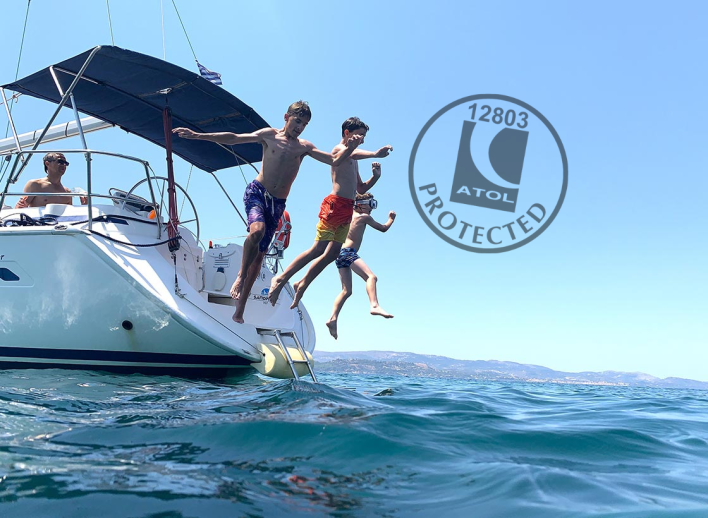 Kids jumping off the back of a yacht into the sea as part of a flotilla in Kefalonia. ATOL logo overlayed on image to show holiday is ATOL protected.