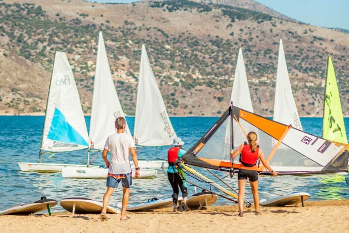 Family rig windsurf sails on a beach