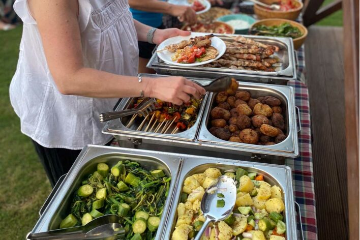 Woman helps herself to buffet food