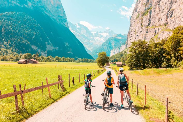 A family riding bicycles in the French Alps in the summer
