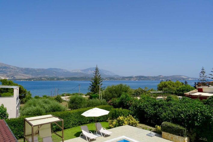 Sea view from a 1st floor balcony. Edge of a villa pool can be seen at the bottom of the image