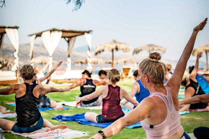 A group of women join in a seated stretching class