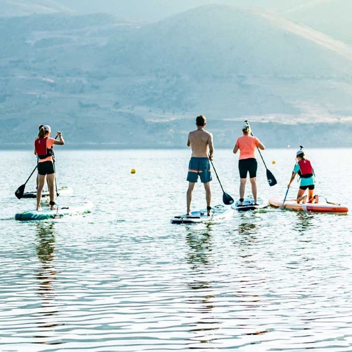 Four people paddle boarding on the sea