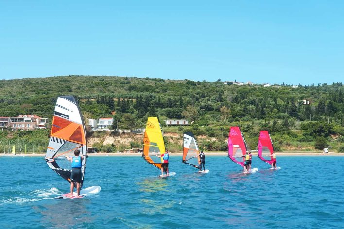 A group of RYA Windsurf students sail along in a line